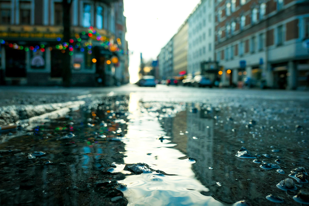 Image of a puddle on a rainy city street.